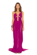 Front view of the fuchsia Venus wet look gown, showing a chain neckline, bodice cutouts and a long draped skirt.