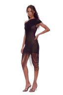 Angled front view of the black asymmetric draped sheer midi dress, showing an asymmetric neckline, curved sheer stripes and long looped fringe.