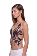 Aurevia halter crop top in Metallic Black, front three-quarter view of the metallic phoenix design.