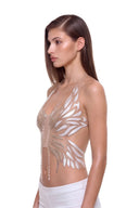 Aurevia halter crop top in Metallic Gold, front three-quarter view of the metallic phoenix design.