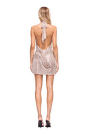 back view of the Bella Metallic Wetlook Halter Mini Dress in blush, showing its draped silhouette.