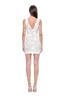 Fiora hand-painted floral mini dress in White, back view showing the V back and raised flower and leaf pattern