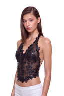 Florielle floral halter top in Black, three-quarter front view showing raised hand-painted flowers, hand-beaded centers and the shaped hem.