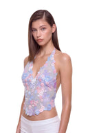 Florielle floral halter top in Pastel Blue, three-quarter front view showing raised hand-painted flowers, hand-beaded centers and the shaped hem.