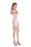 Side view of the light pink fringed sheer asymmetric mini dress, showing a sleeveless silhouette, curved sheer stripes and looped fringe at the hem.