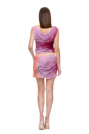 Back view of the Marea Sunset Gradient wetlook skirt set with a low draped neckline and curved folds across the mini skirt.