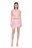 Front view of the light pink Marea wetlook two-piece set, showing a sleeveless draped crop top and asymmetric mini skirt.
