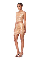 Front three-quarter view of the Marea Metallic Gold wetlook two-piece set with luminous sculpted folds and sheer panels