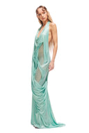 Three-quarter view of the Siren wetlook long dress showing sculptural draping, halter neckline and sheer panel detailing