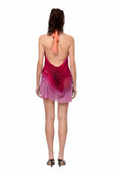 Back view of the Solara sunset gradient wetlook mini dress with open back and draped mini silhouette
