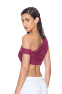 back three quarter view of the Thalia Fuchsia One-Sleeve Wet Look Crop Top, with a single shoulder strap, one short off-shoulder sleeve and sheer draping.