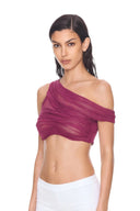 front three quarter view of the Thalia Fuchsia One-Sleeve Wet Look Crop Top, with a single shoulder strap, one short off-shoulder sleeve and sheer draping.