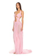 Opposite front three-quarter view of the light pink Venus wet look gown, showing a chain neckline, bodice cutouts and a long draped skirt.